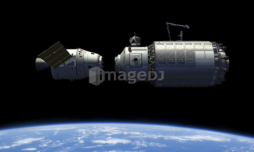 A manned reusable crew capsule docks with an orbital maintenance platform.