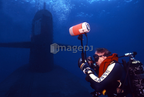 Underwater photographer takes photos of a U.S. submarine.