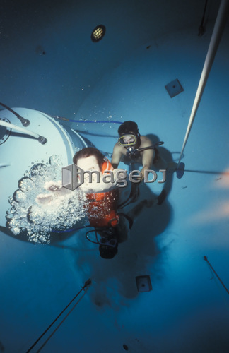 Diving bell instructor releases control of the buoyant ascent student as he begins the rapid ascent to the surface