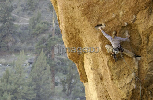 Woman (20-25) rock climbing in Smith Rock State Park, Oregon, USA