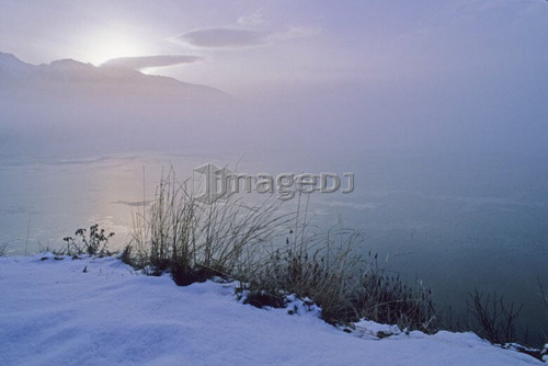 Early morning sun rises over Whistler mountain and Green Lake, B.C.