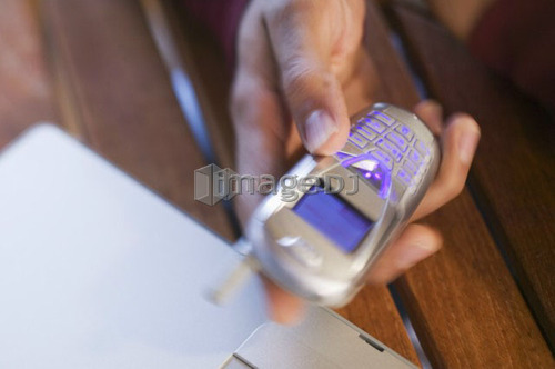 East Indian man and cellphone, West Vancouver, B.C.