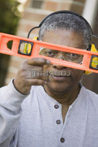 African American man and a construction level, B.C.