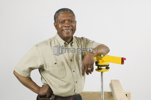 African American Man Doing Home Improvement, Using Laser Level, B.C.
