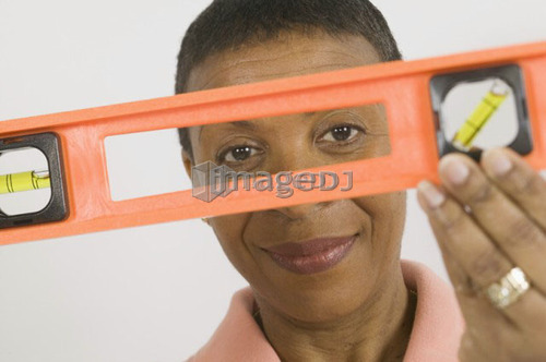 African American Woman Doing Home Improvement, Using a Spirit Level, B.C.