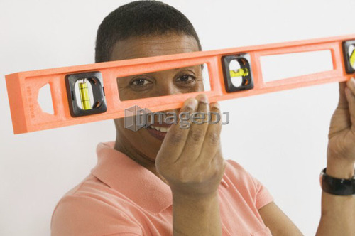 African American Woman Doing Home Improvement, Using a Spirit Level, B.C.