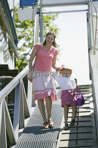 Caucasian Mom and 4 year old Daughter, walking down a ramp to a boat dock, Granville Island, Vancouver, B.C.