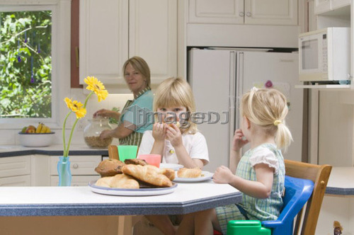 Mom and 3 and 5 year old daughters having breakfast, B.C.