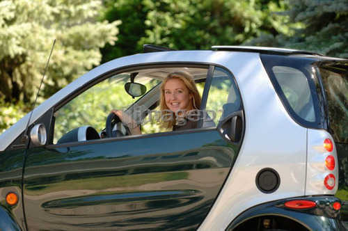 Young woman sitting in smart car, Regina, Saskatchewan