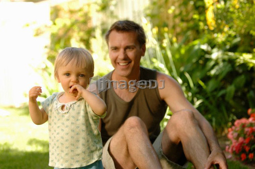Dad & baby in grass, Regina, Saskatchewan
