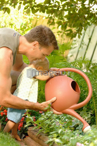 Dad & baby playing with watering can, Regina, Saskatchewan