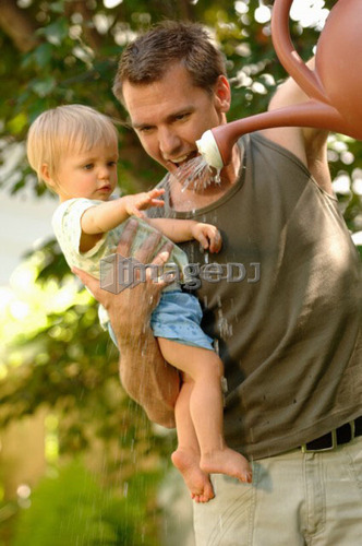 Dad & baby playing with watering can, Regina, Saskatchewan