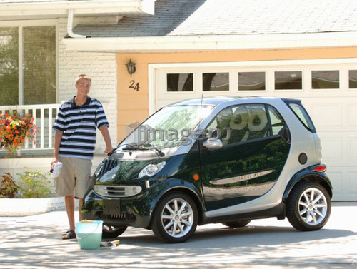 Teenage boy washing smart car, Regina, Saskatchewan