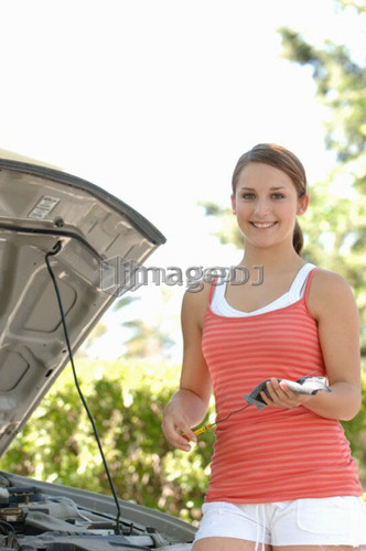 Teenage girl checking oil, Regina, Saskatchewan
