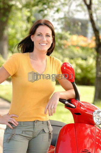 Young woman posing with red vespa, Regina, Saskatchewan