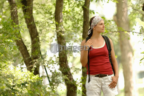 Woman hiking in woods, Regina, Saskatchewan