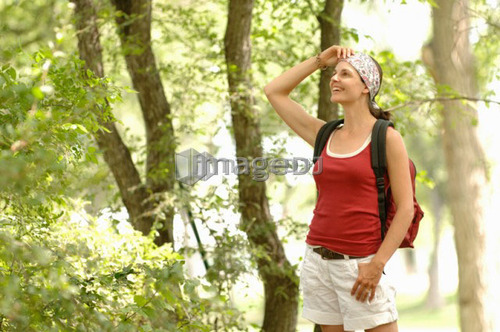 Woman hiking in woods, Regina, Saskatchewan