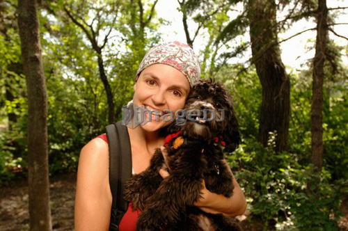 Woman hiker with dog in woods, Regina, Saskatchewan