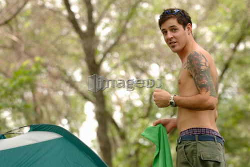 Young man w/tattoo in front of tent, Regina, Saskatchewan