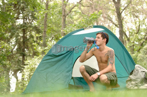 Young man w/tattoo in front of tent, Regina, Saskatchewan
