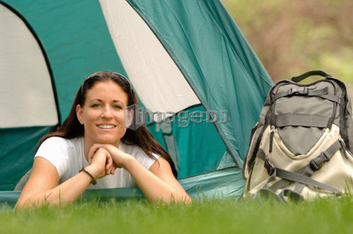 Young woman laying out front of tent, Regina, Saskatchewan