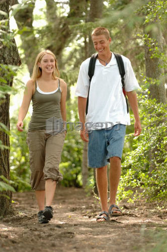 Young couple walking in woods, Regina, Saskatchewan