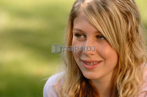 Portrait of young blonde girl on grass, Regina, Saskatchewan