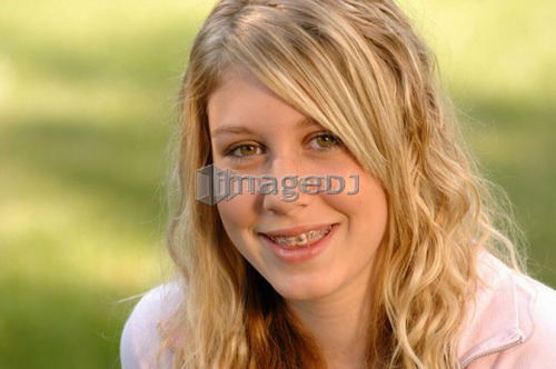 Portrait of young blonde girl on grass, Regina, Saskatchewan