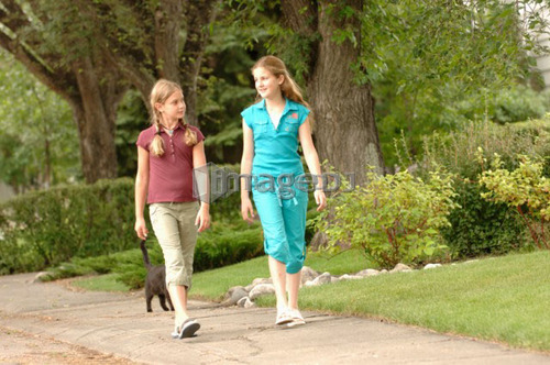Young girls walking down street, Regina, Saskatchewan