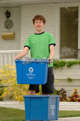 Boy taking recycling to curb, Regina, Saskatchewan