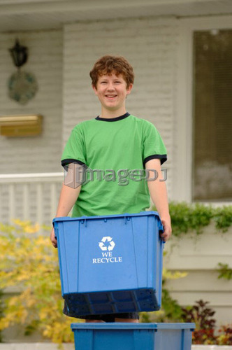 Boy taking recycling to curb, Regina, Saskatchewan