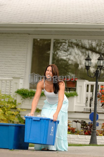 Woman taking recycling to curb, Regina, Saskatchewan