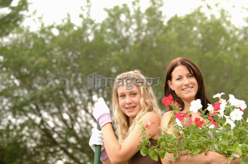 Woman and girl with rake and flowers, Regina, Saskatchewan
