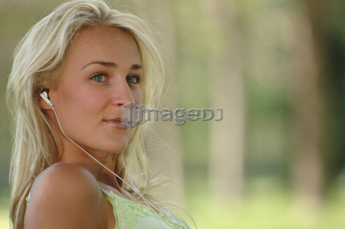Young blonde female in park with earphones, Regina, Saskatchewan