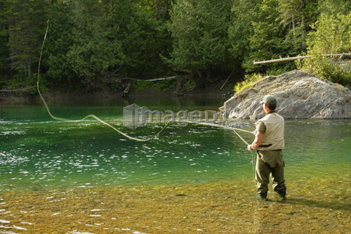 View of fisherman (salmon fishing) on Petite Cascapédia river (Arthur Rock salmon pool)