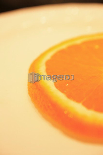 Slice of orange on plate