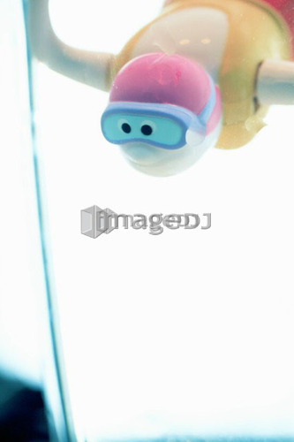 Child's bathtub toy in glass of water