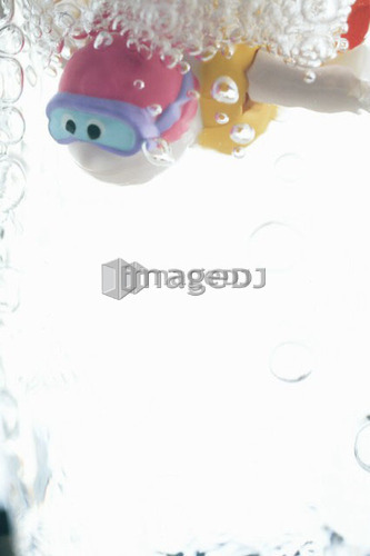 Child's bathtub toy in glass of water