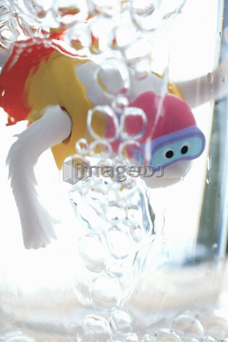 Child's bathtub toy in glass of water