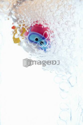Child's bathtub toy in glass of water