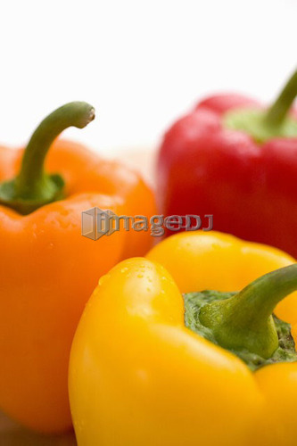 Close-up of yellow, orange and red peppers
