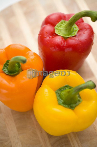 Yellow, orange and red peppers from above
