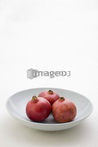 3 Pomegranates in low bowl