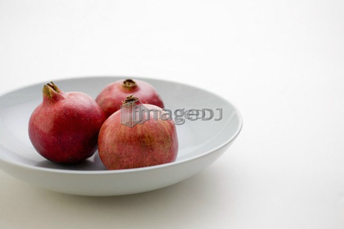3 Pomegranates in low bowl