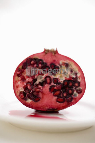 Half a pomegranate on a white plate