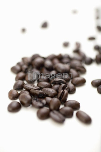 Coffee beans on white surface