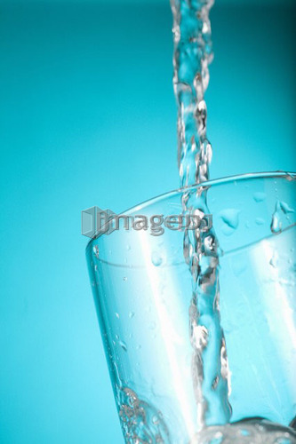 Water pouring into clear glass