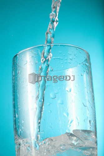 Water begins pouring into clear glass