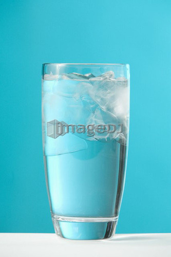 Clear glass of water with ice chips