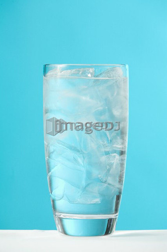 Very full glass of water with ice